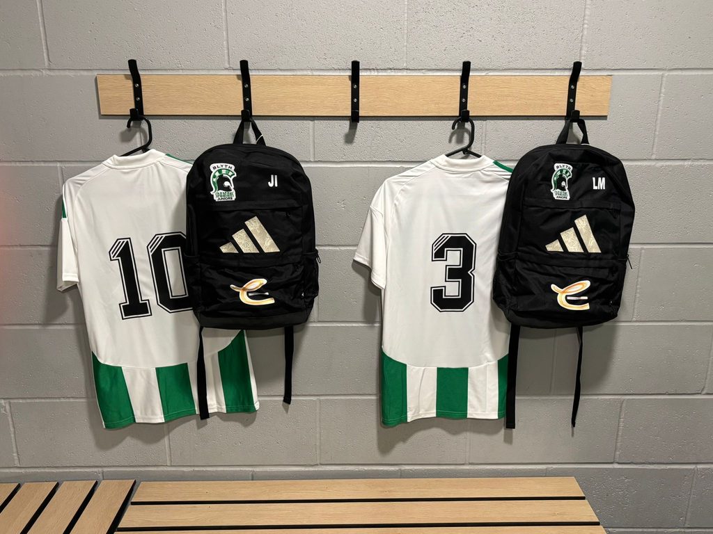 football kit hanging on hangers with sponsorship showing.